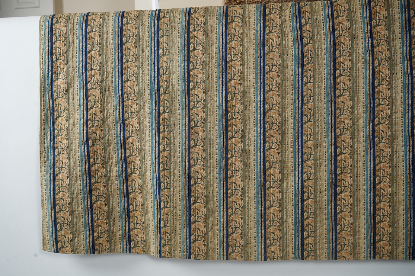 An early 1900’s American, possibly Pennsylvanian ‘robbing Peter to pay Paul’ quilt. Made with brick red and complimentary yellow tiny spot floral printed cotton. With a wide older chintz cotton border and block printed c